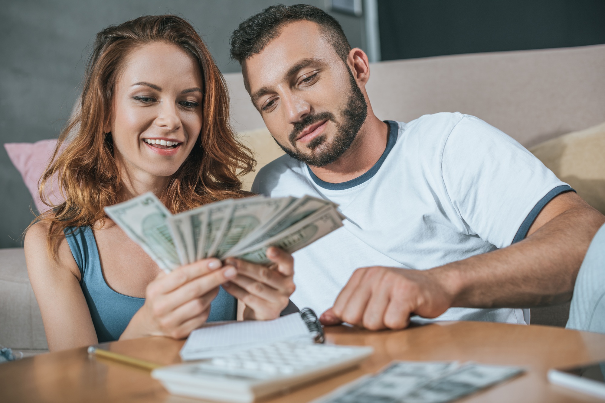 couple planning family budget in living room