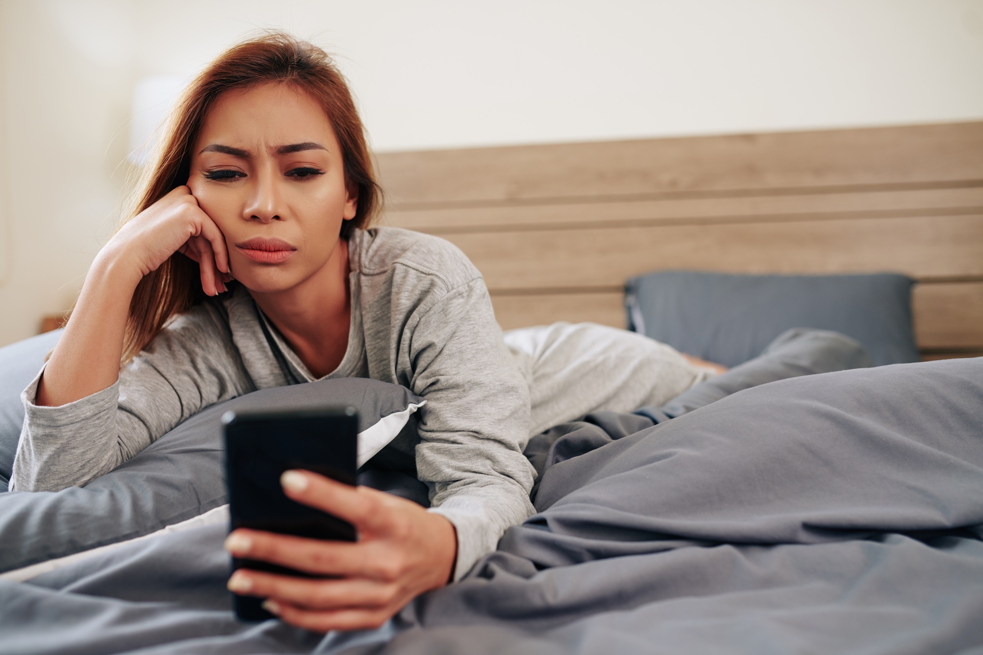 Woman reading bad news online