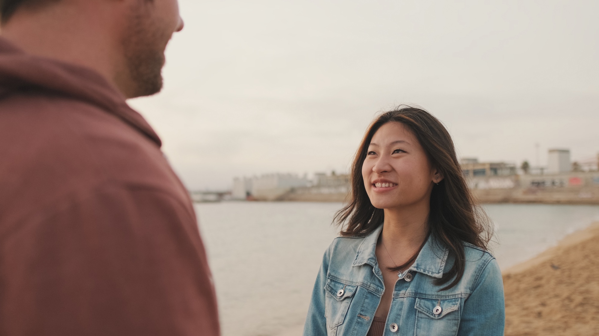 Young couple are talking to each other on the seascape