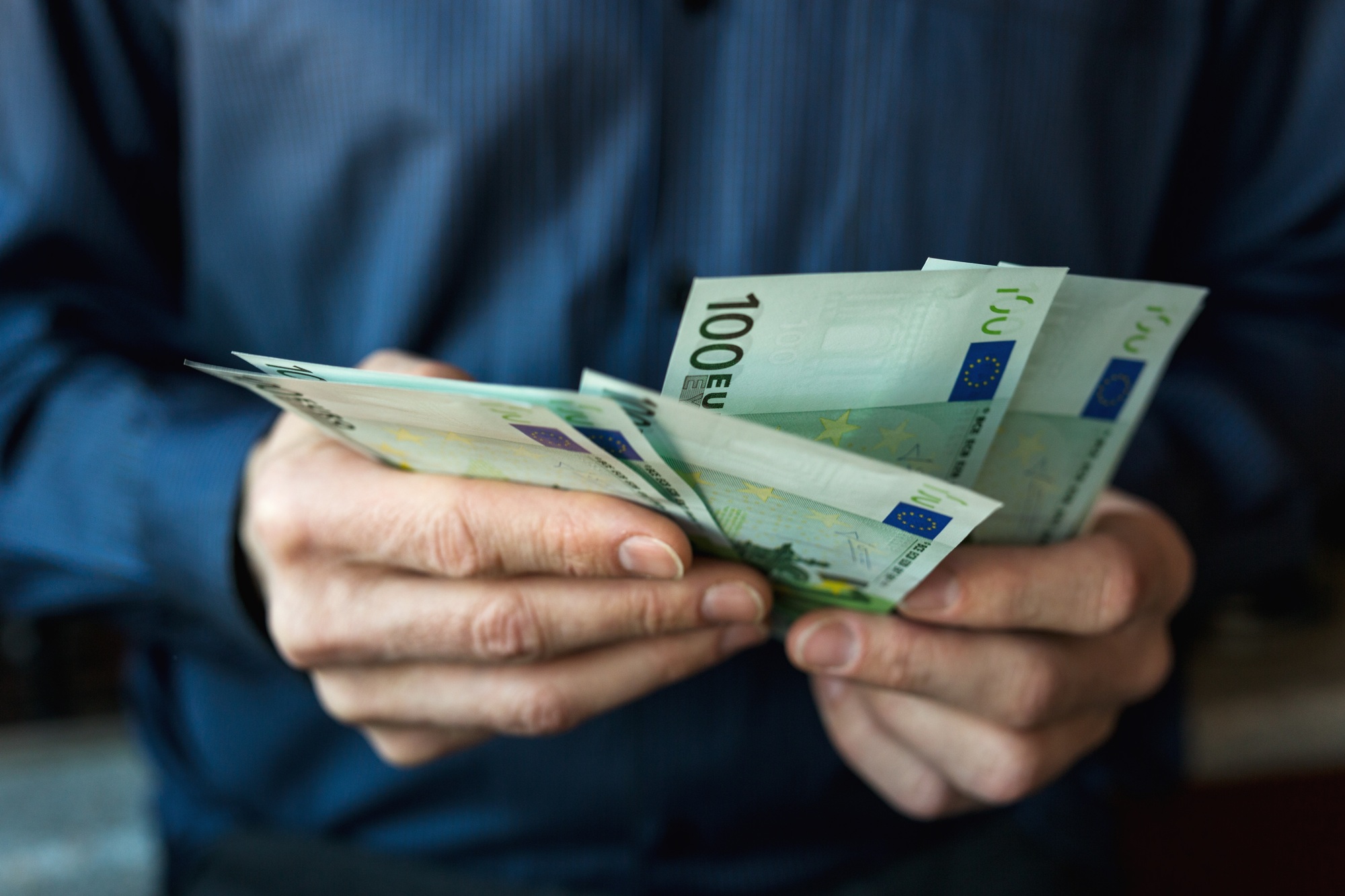 Men's hands count Euro bills cash money